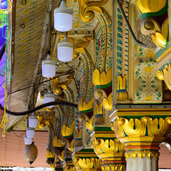 Low angle view of illuminated lamp in building