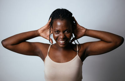 Portrait of smiling woman against white background