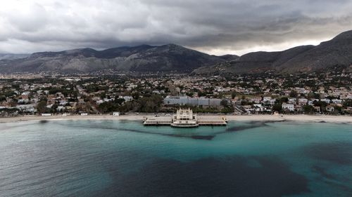 Scenic view of sea and mountains against sky