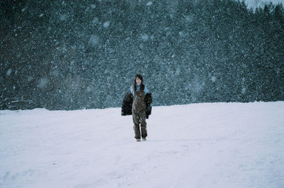 Man standing on snow covered land