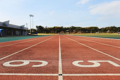 Number on running track against sky