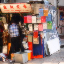 Rear view of people standing at store