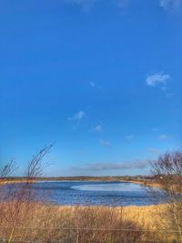 Scenic view of sea against blue sky