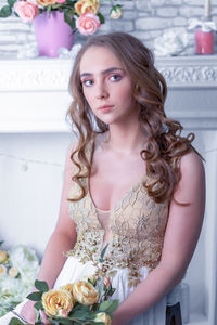 Portrait of beautiful young woman with bouquet