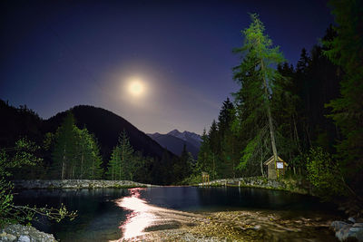 Scenic view of lake against sky at night