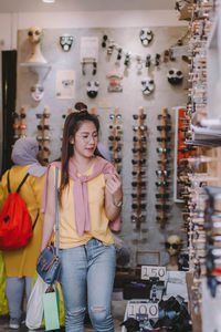 Young woman standing at market stall