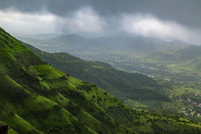 Scenic view of green mountains against sky