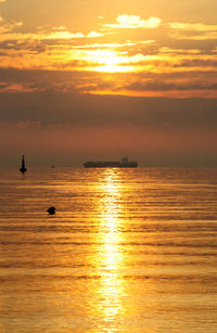 Scenic view of calm sea at sunset