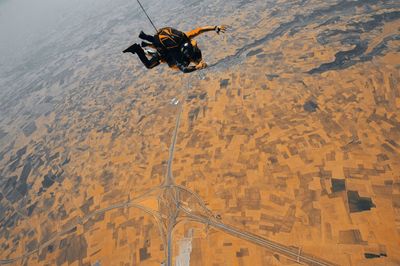 High angle view of person paragliding against the sky