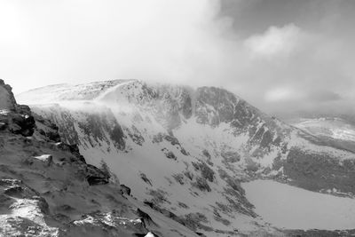 Scenic view of snow covered mountains against sky