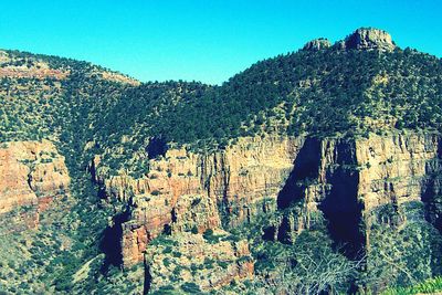 Scenic view of rocky mountains against clear blue sky