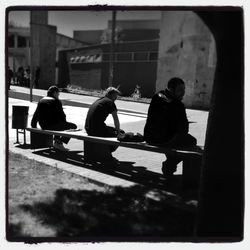 Full length of woman sitting on bench