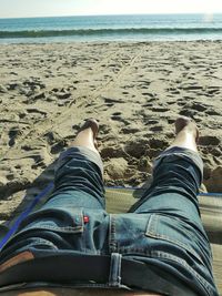 Low section of woman standing on beach