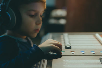 Cute boy mixing music in recording studio