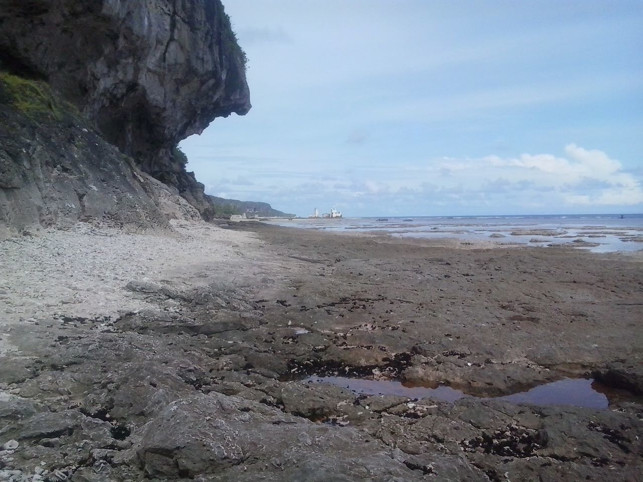 sea, water, beach, horizon over water, shore, sky, tranquility, scenics, tranquil scene, rock - object, beauty in nature, rock formation, sand, nature, coastline, cliff, idyllic, rock, incidental people, day