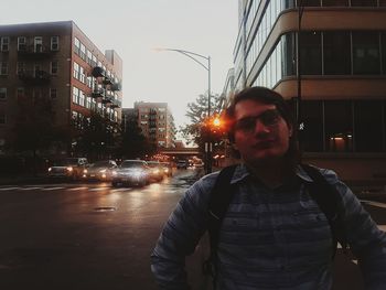 Young man standing on road in city