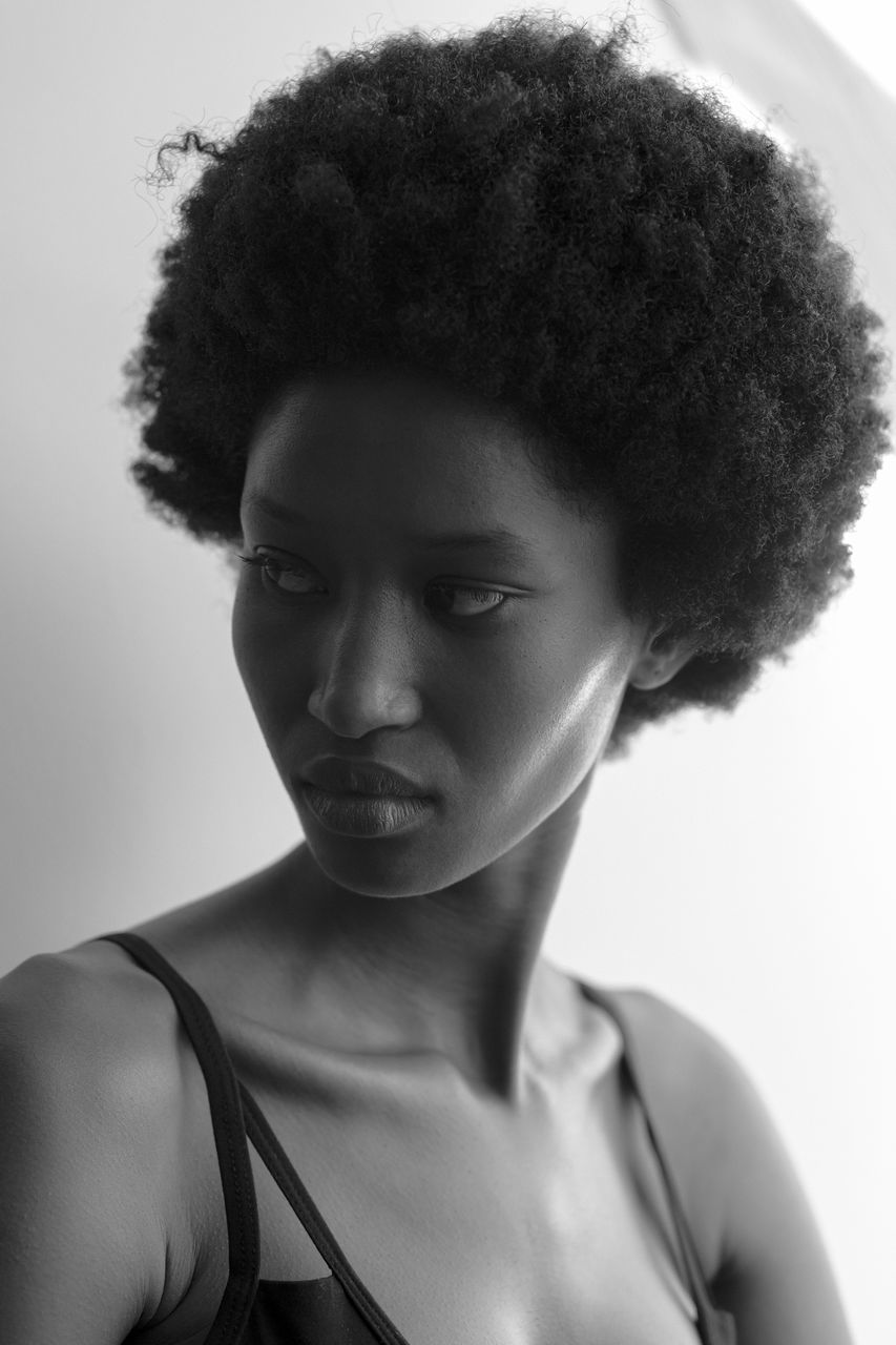 human hair, portrait, one person, hairstyle, black and white, afro, black, curly hair, young adult, adult, headshot, monochrome, monochrome photography, women, studio shot, indoors, serious, black hair, front view, human face, close-up, looking at camera, fashion, looking, clothing, photo shoot, lifestyles, short hair, long hair