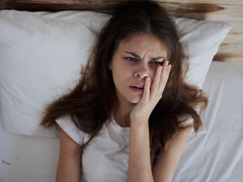 Portrait of woman lying on bed