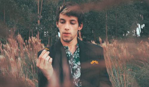 Portrait of young man looking at forest