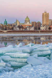 View of frozen river in city