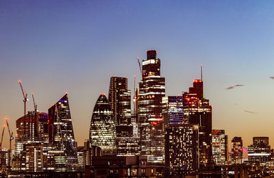 Illuminated buildings against the sky at twilight