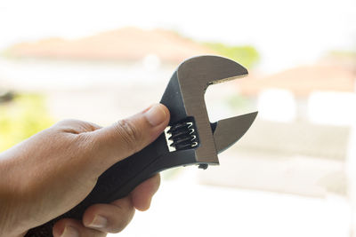 Close-up of hand holding wrench