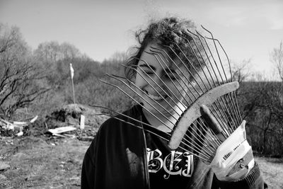 Close-up of cheerful woman holding gardening fork