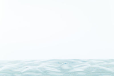 Close-up of bubbles over sea against sky