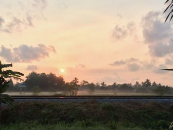 Scenic view of field against sky during sunset