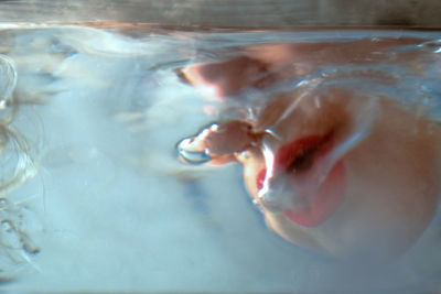 Close-up of person swimming underwater
