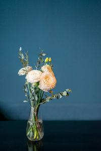 Beautiful ranunculus flowers on blue background with frame mock up