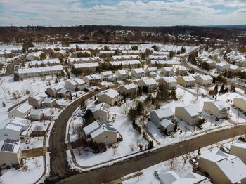 High angle view of snow covered houses against sky