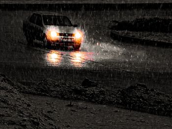 Wet car on street at night