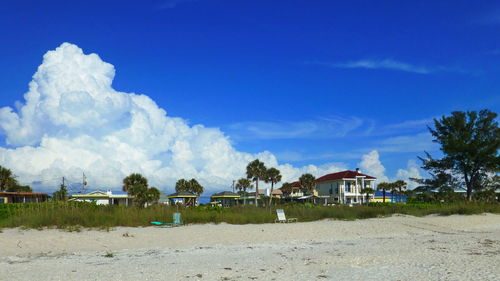 Panoramic view of beach and houses against sky