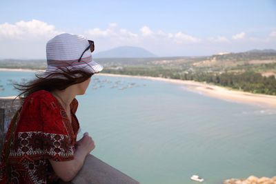 Woman looking at beach while standing at observation point