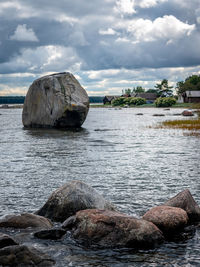 Rocks on sea shore against sky