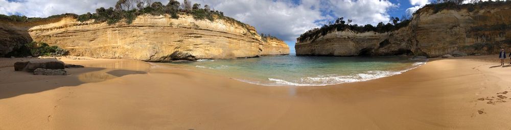 Panoramic view of rocks on beach against sky