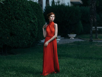 Portrait of woman standing on field