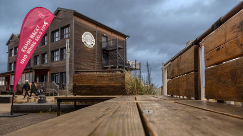 Exterior of restaurant by building against sky