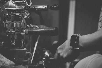 Close-up of man using mobile phone in cafe