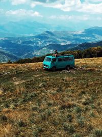 View of car on field against mountains