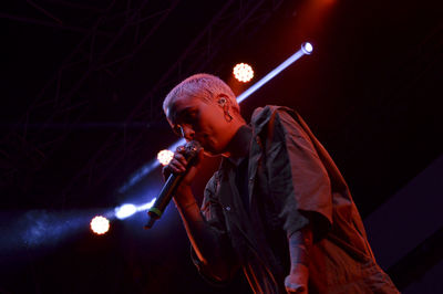 Full length of man holding illuminated light at night