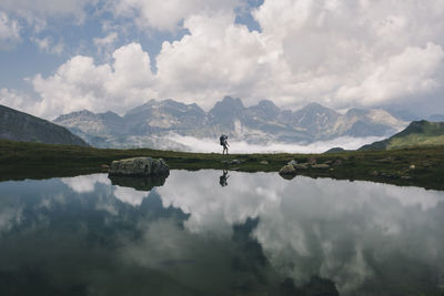 Scenic view of lake and mountains against sky