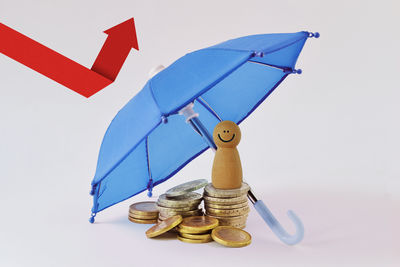 Low angle view of umbrella against blue background