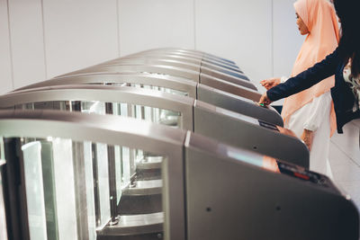 Midsection of woman standing by railing