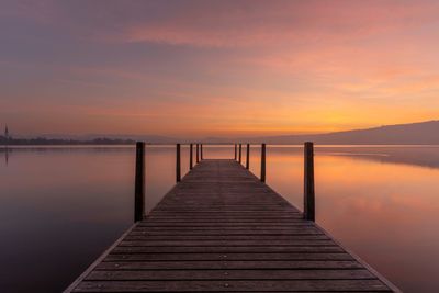 Pier over sea against sky during sunrise lake of zug