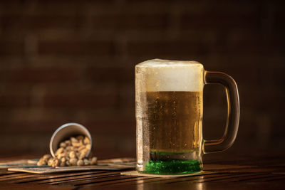 Close-up of beer glass on table