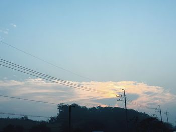 Low angle view of birds perching on power line