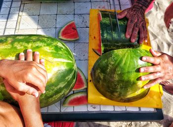 Midsection of man holding fruits