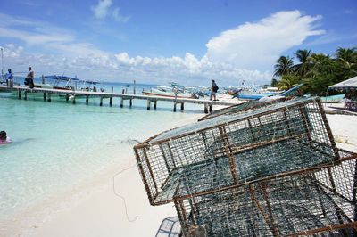 Tropical beach against cloudy sky